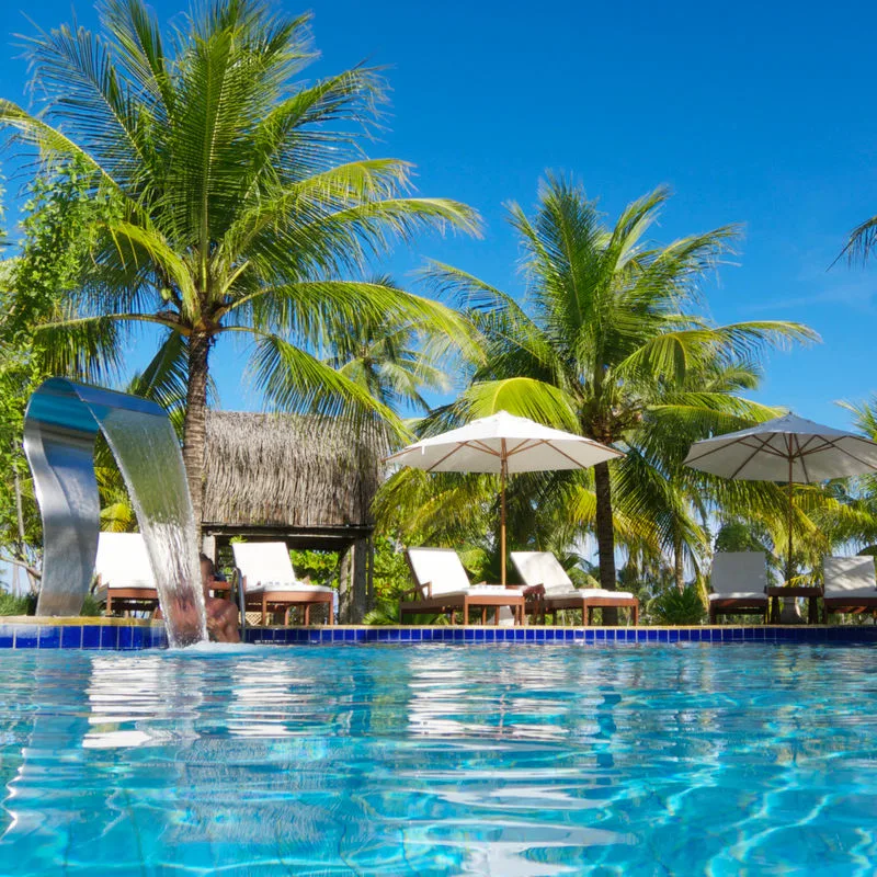 Resort pool with crystal clear water and lounge chairs 