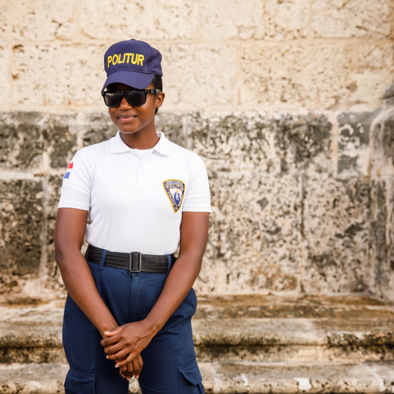 Tourist police agent standing in front of an old building