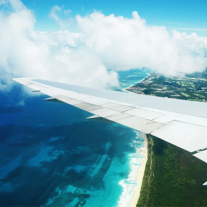 Airplane over Caribbean destination