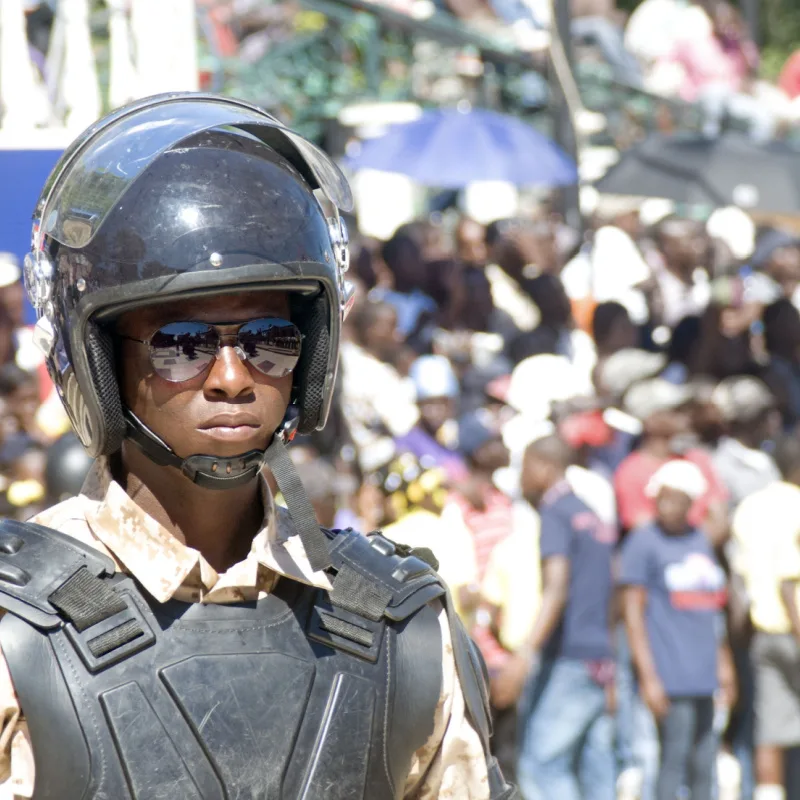 Haiti police in a large crowd during protest 