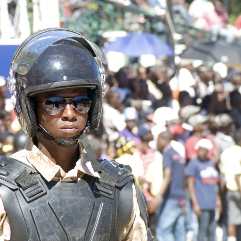 Haiti police in a large crowd during protest