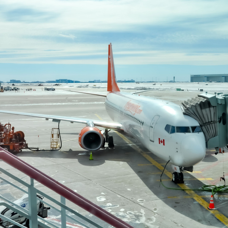 Sunwing aircraft parked on a terminal gate 