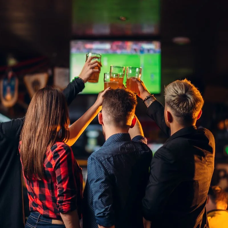 Friends watch sports in a bar