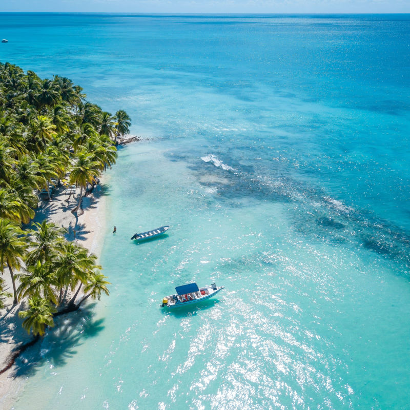 aerial view of boat in the dominican republic crystal clear blue waters