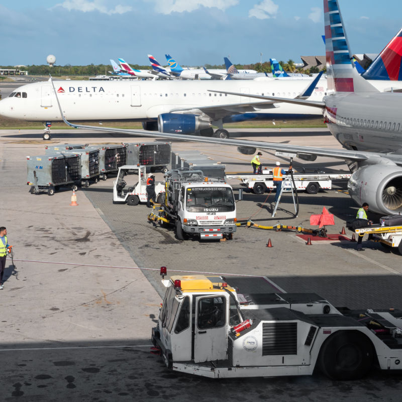 American Airlines plane and airport vehicles
