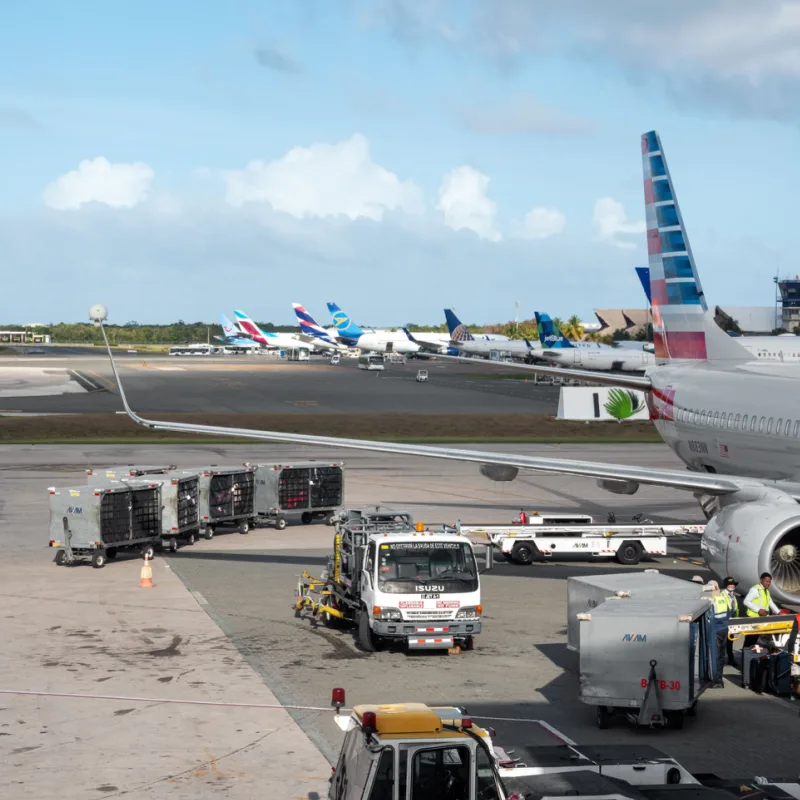 Busy airport scene in the Dominican Republic with American Airlines plane