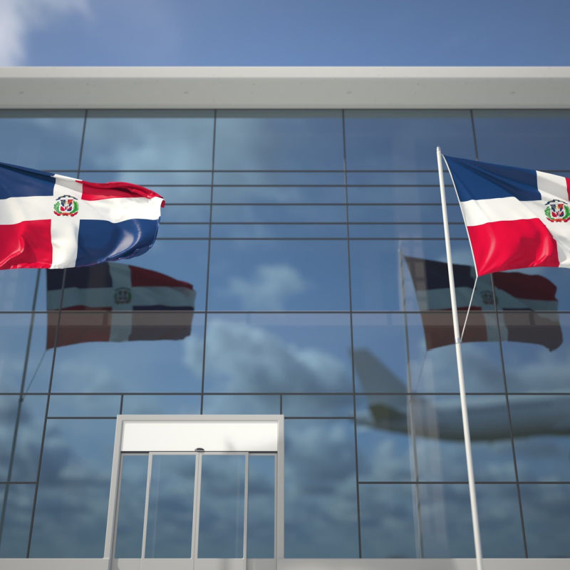 Dominican Republic flags in front of massive building