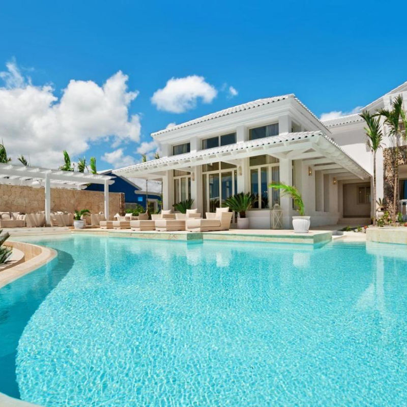 Stunning blue pool water in Eden Roc Cap Cana with lavish villa
