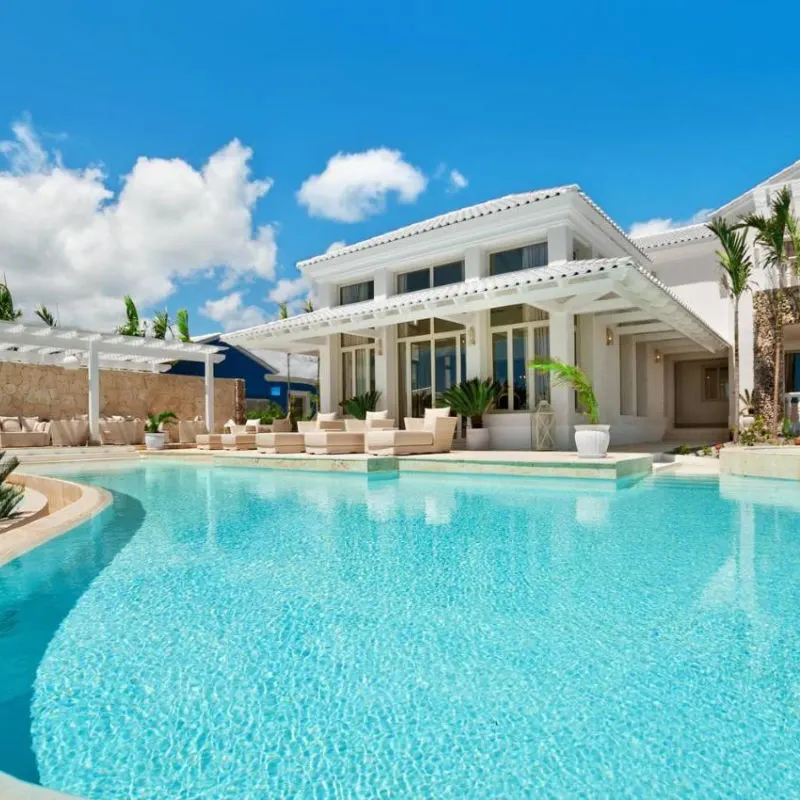 Stunning blue pool water in Eden Roc Cap Cana with lavish villa