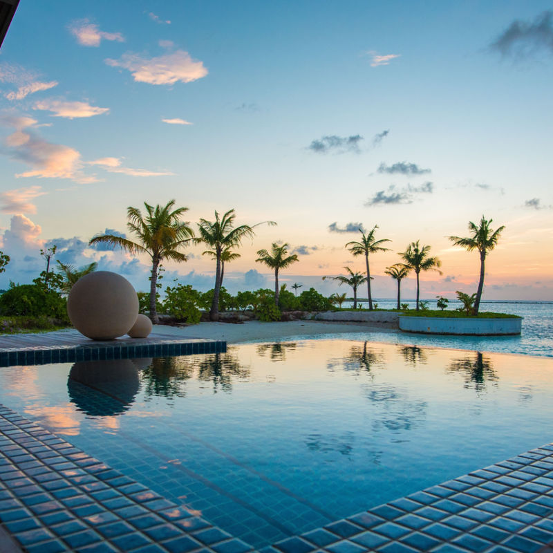 Infinity pool and sunset in Caribbean