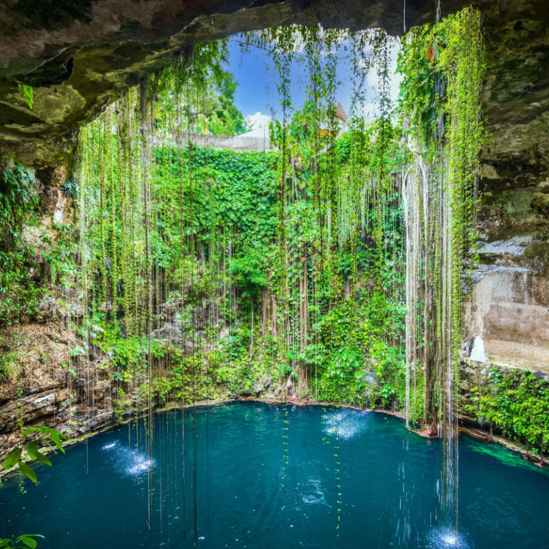 A cenote in the Caribbean with blue water