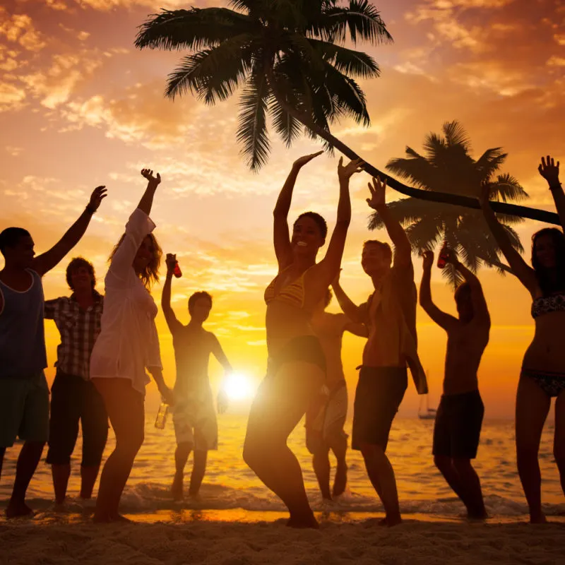 Partygoers at a Punta Cana beach during sunset