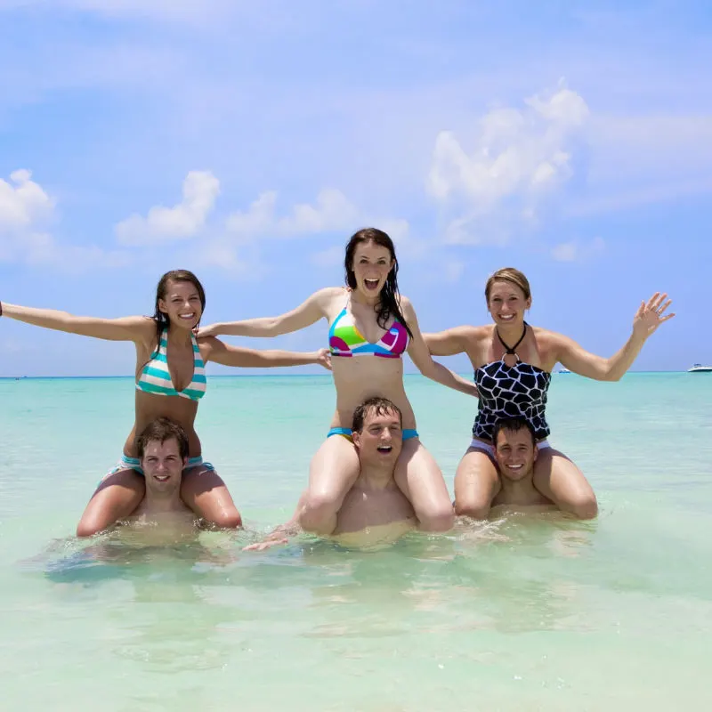 A group of young travelers having fun in the ocean