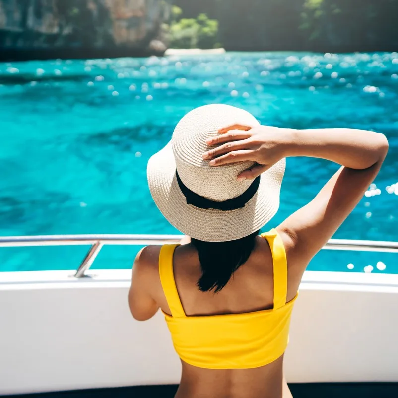 Woman on boat wearing a hat