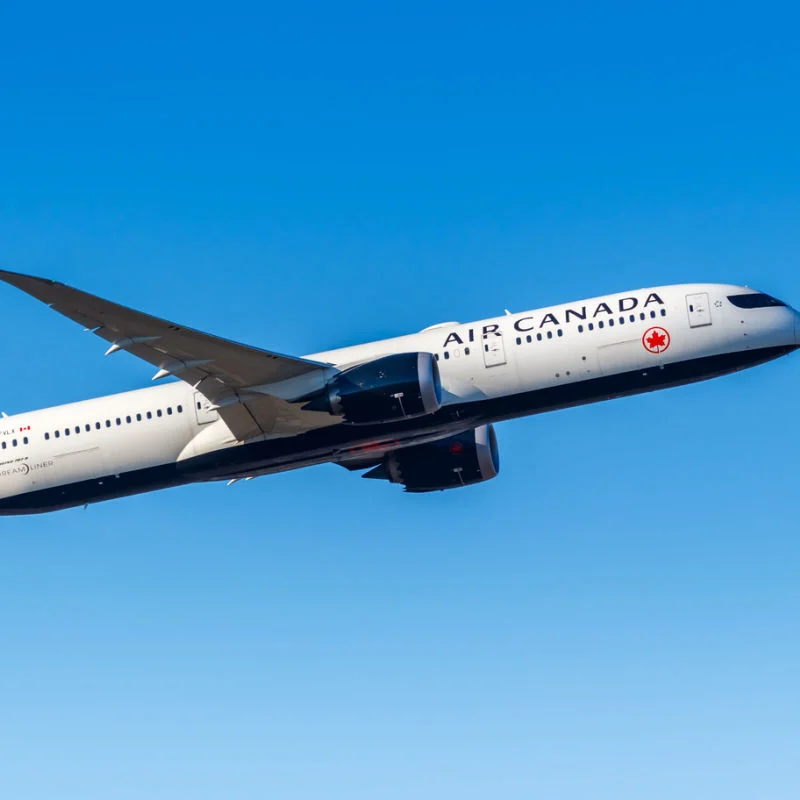 An Air Canada flight departing amid blue skies