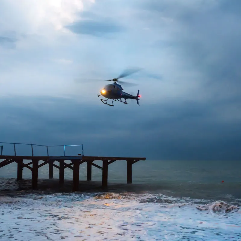 A helicopter performing an emergency landing on a pier 