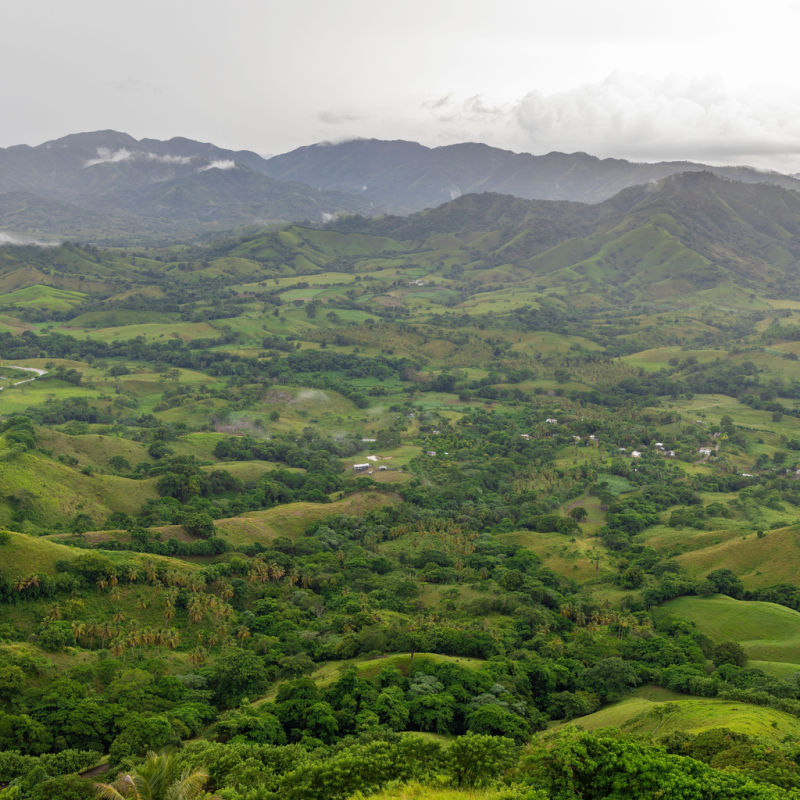 A green area in the Dominican Republic with mountains in background 