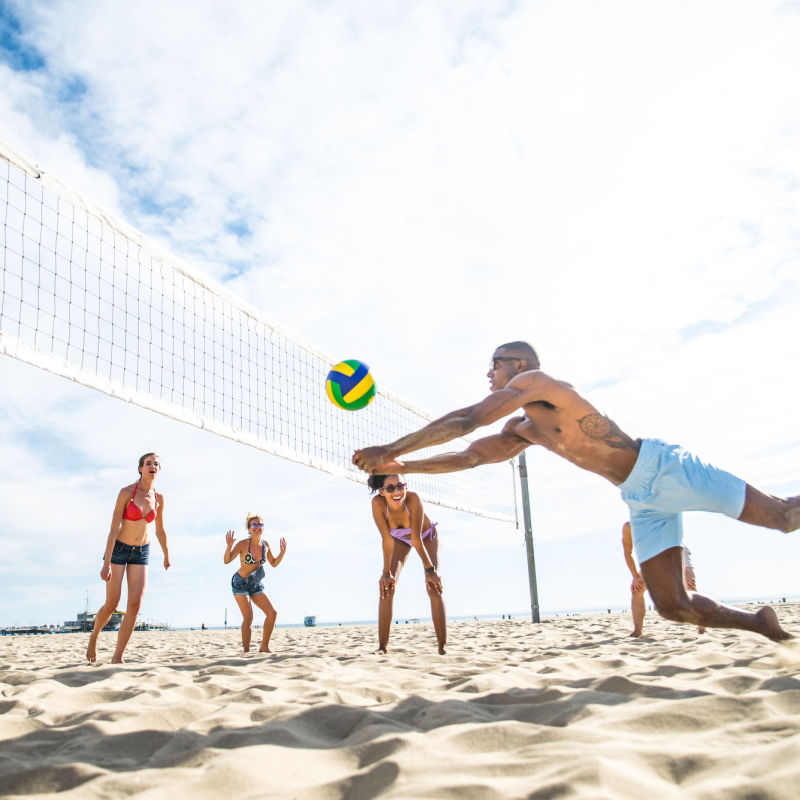 Young travelers enjoying volleyball in a Punta Cana beach