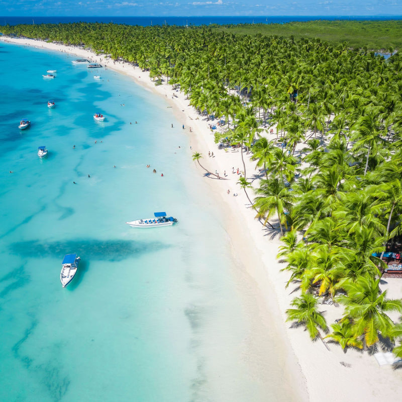 Aerial view of a white sand beach in Punta Cana with boats 