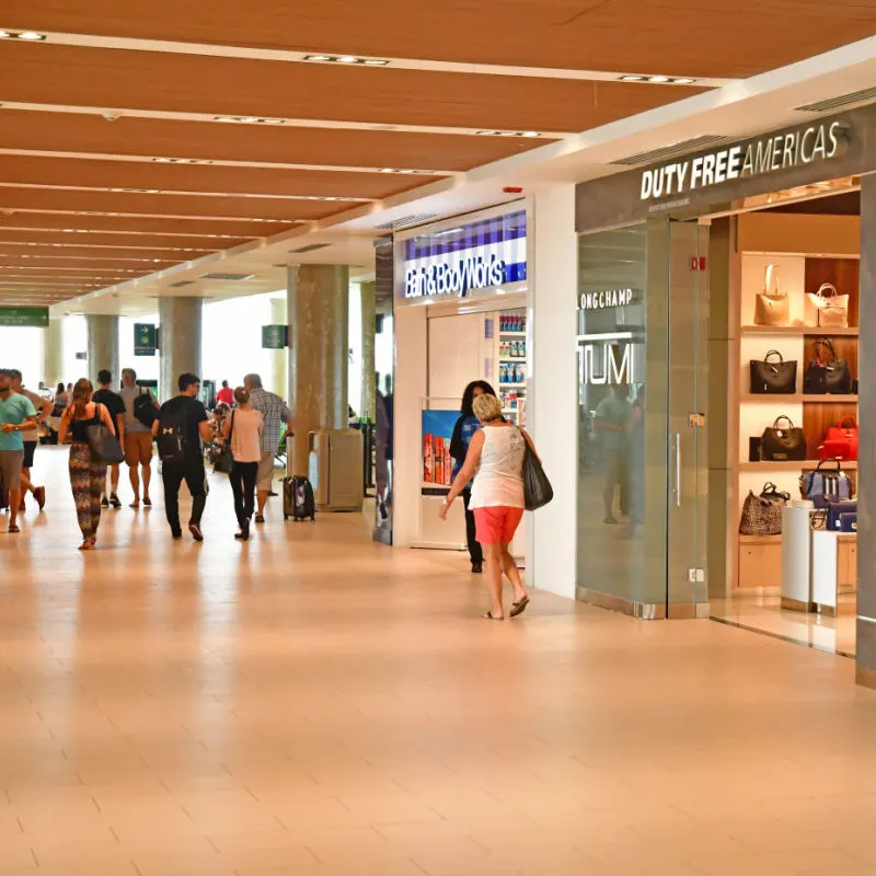 Travelers walking and shopping Duty Free inside Punta Cana Airport