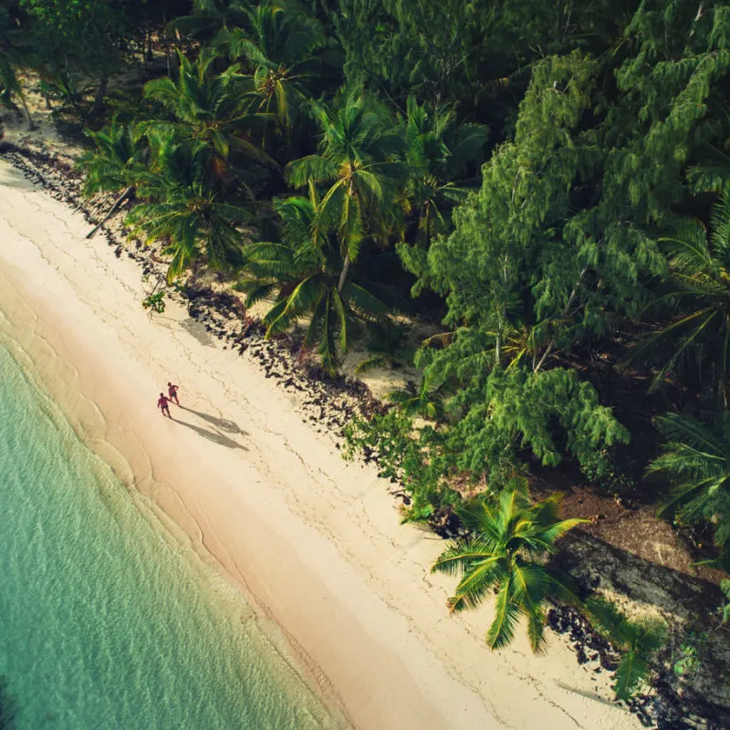 Travelers on a Miches white-sand beach