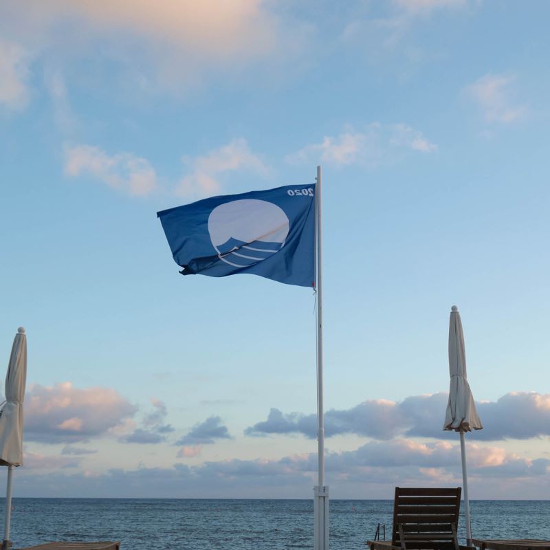 Blue flag certification flag on a beach