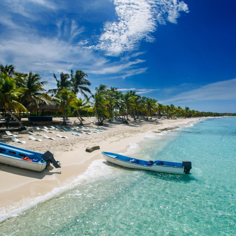 A remote tropical island in the Dominican Republic with boats