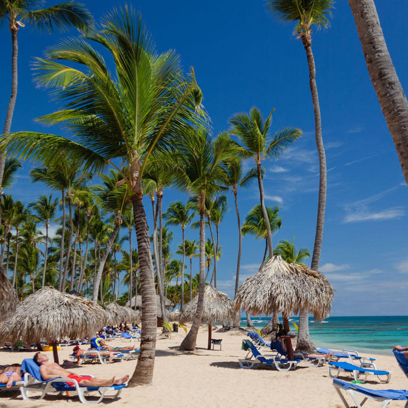 Punta Cana white-sand beach with travellers 