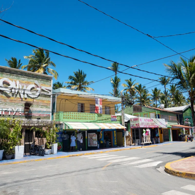 A street in Punta Cana with shops and street crossing
