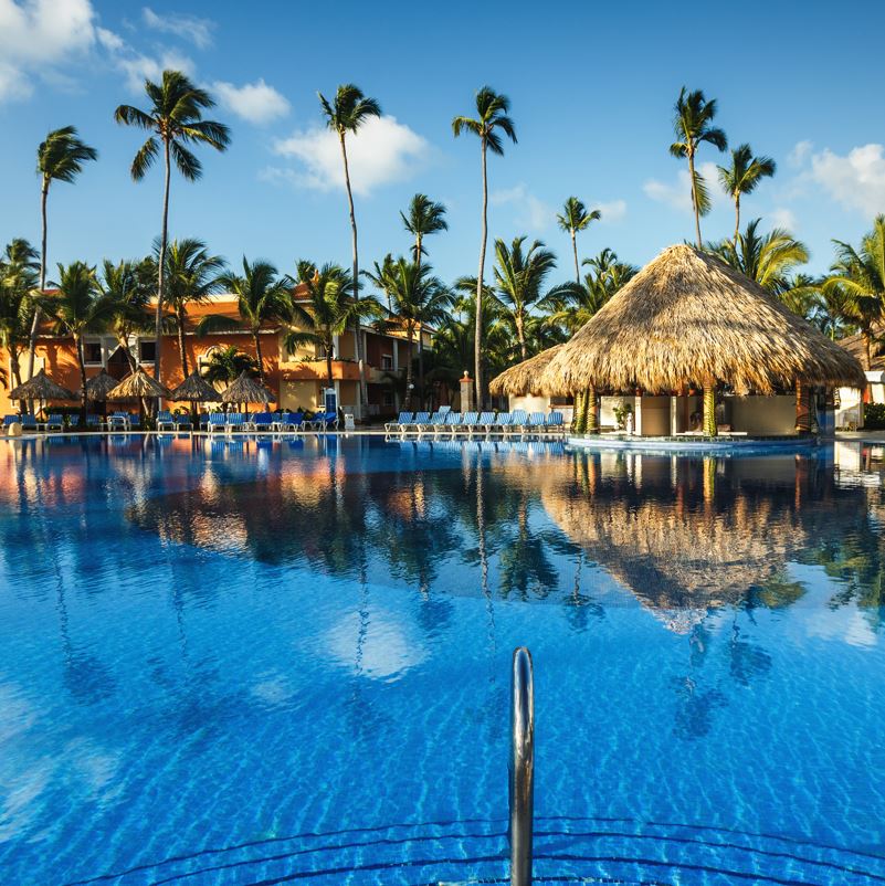 A resort pool with palm trees in Punta Cana 