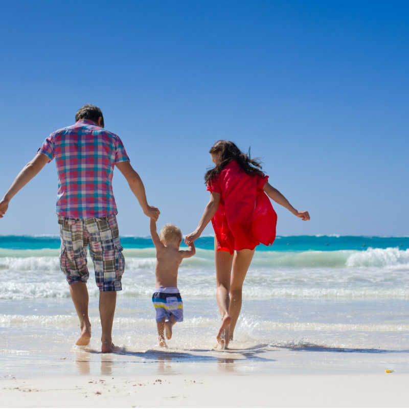A family on vacation in punta cana on a white sand beach 