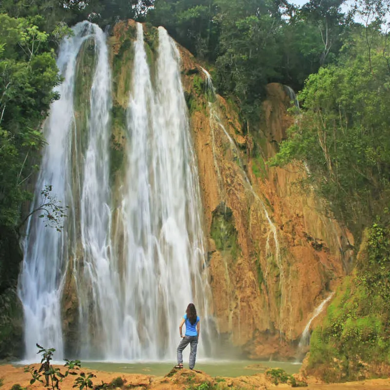 Large waterfall in the dominican republic with traveler 