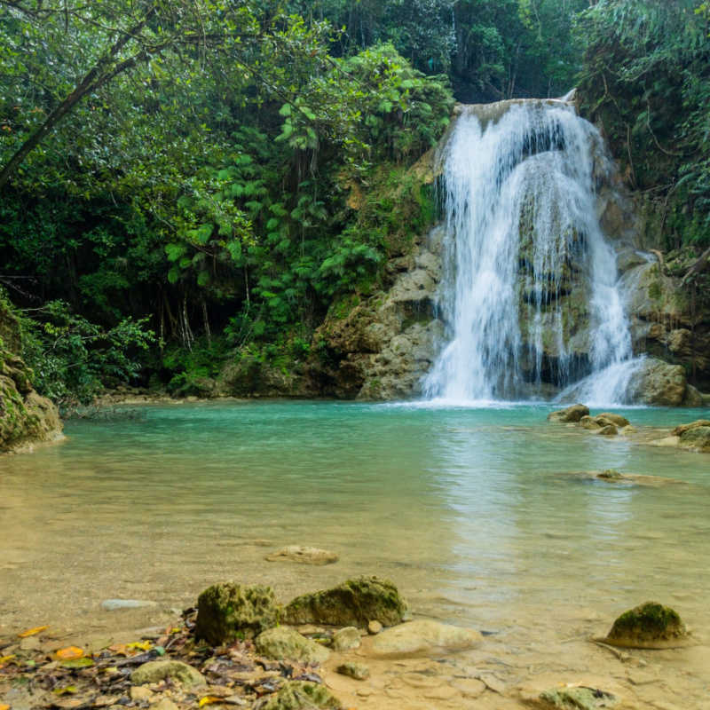 Waterfall in the Dominican Republic with blue water