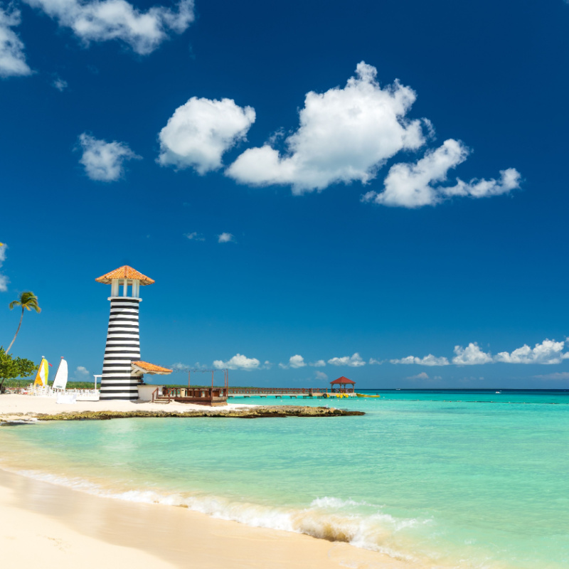 a white sand beach with tower in bayahibe