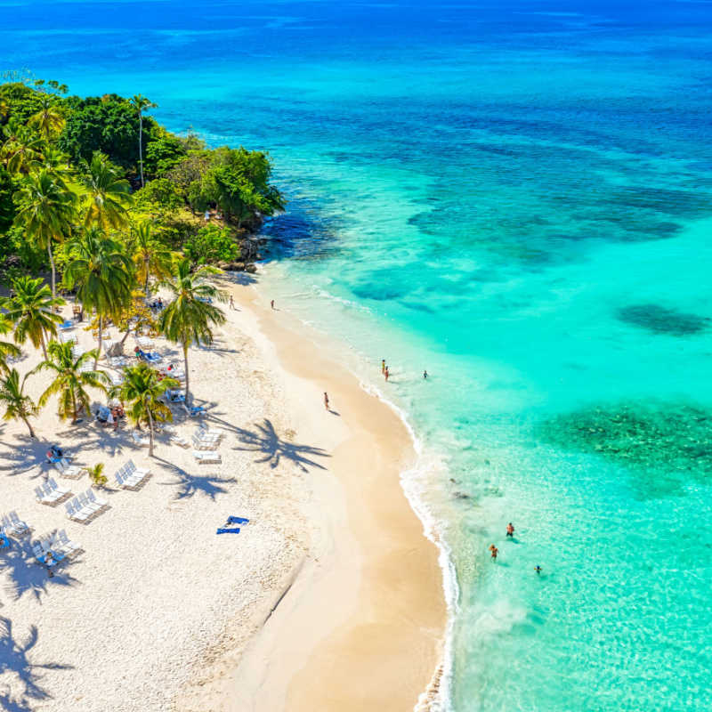 a white sand beach in the dominican republic with blue water