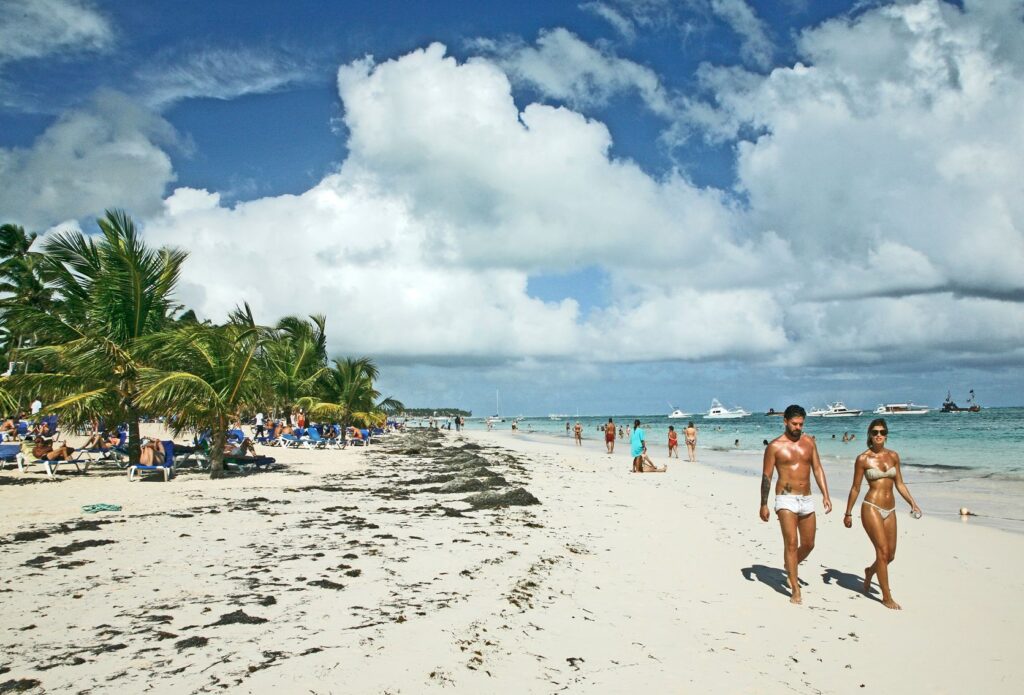 Tourists walking on beach Punta Cana